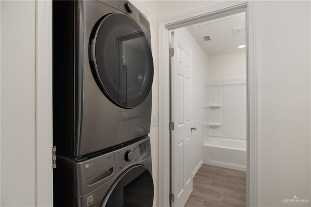 1615 W B St, Mission, TX 78572 - laundry room featuring stacked washer / dryer and light wood-style flooring