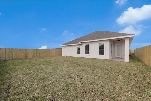 2205 Cardinal Dr, Weslaco, TX 78596 - back of house with a fenced backyard, a ceiling fan, stucco siding, a patio, and roof with shingles