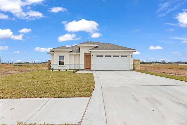 view of front of house with a garage and a front lawn