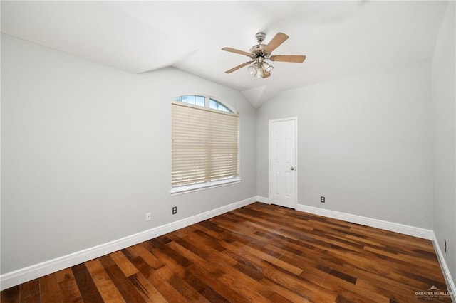 spare room featuring ceiling fan, dark wood-type flooring, and lofted ceiling