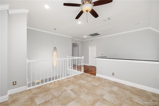 spare room with crown molding and ceiling fan