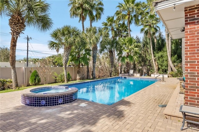 view of pool featuring central air condition unit, a patio area, and an in ground hot tub