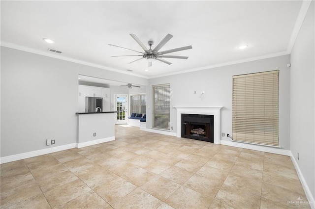 unfurnished living room featuring ceiling fan and ornamental molding