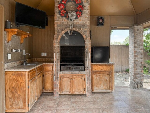 kitchen featuring wood walls and sink