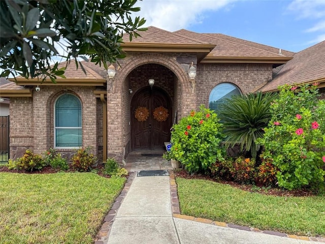 entrance to property with a lawn