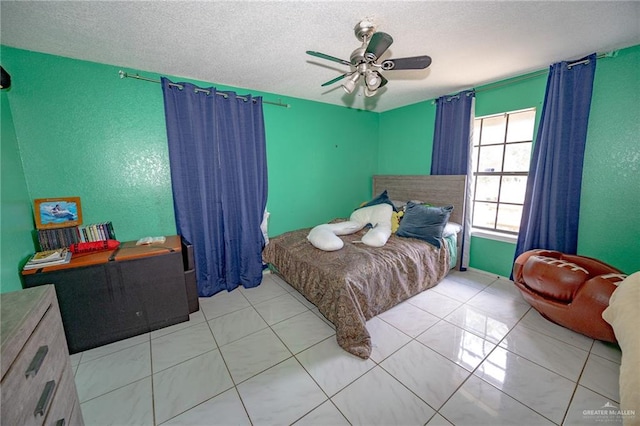 bedroom featuring light tile patterned floors, a textured ceiling, and ceiling fan