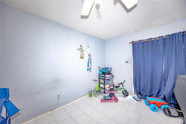 interior space featuring ceiling fan and a textured ceiling