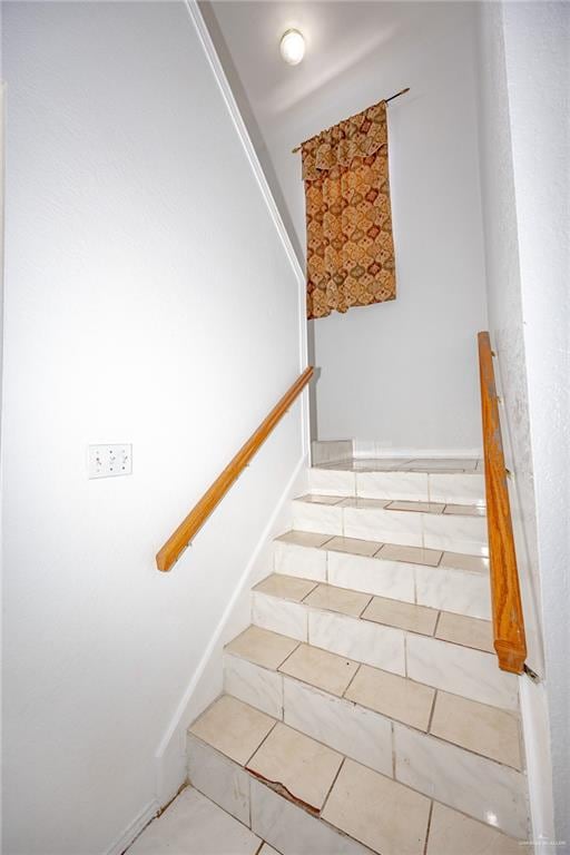 stairway featuring tile patterned floors