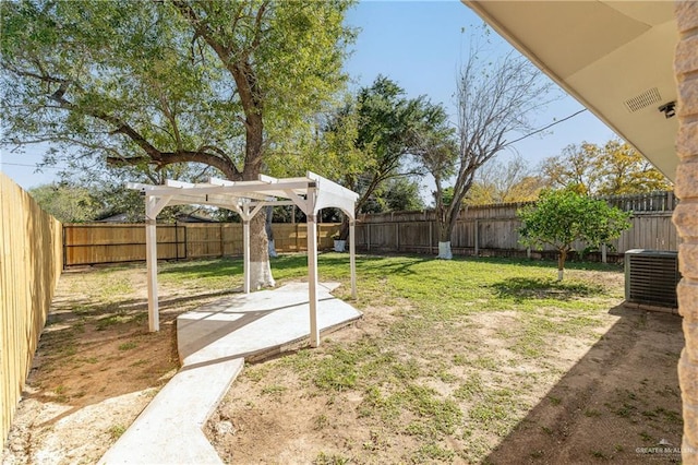 view of yard with central AC unit and a pergola