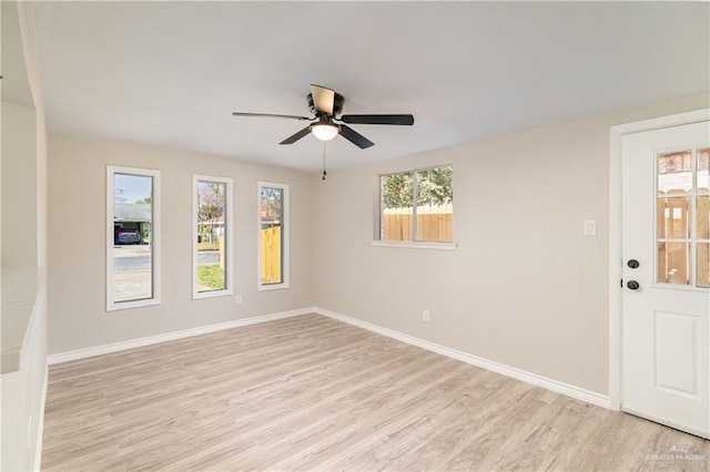 empty room with ceiling fan and light hardwood / wood-style floors