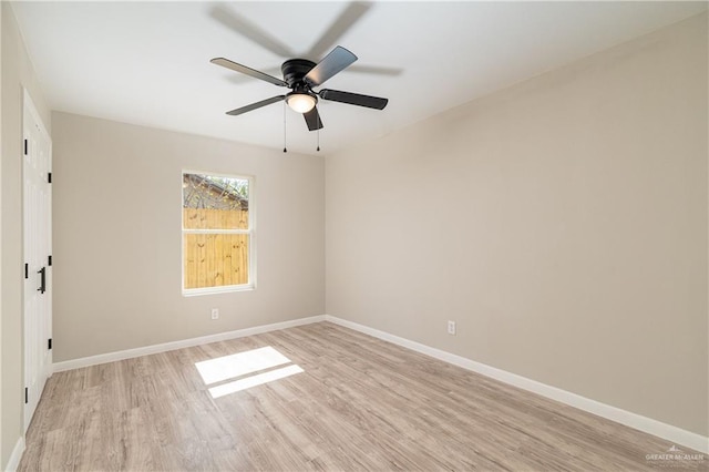 empty room with ceiling fan and light wood-type flooring