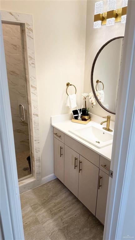 5302 Vision St, Rio Grande City, TX 78582 - bathroom with vanity, a stall shower, and baseboards