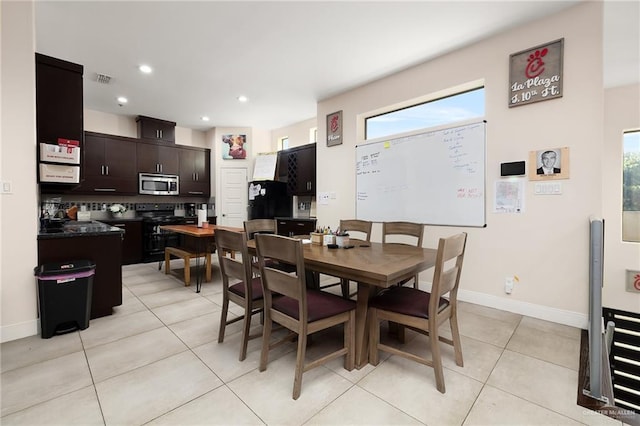 dining room featuring plenty of natural light and light tile patterned floors