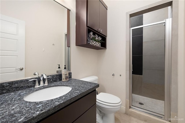 bathroom featuring toilet, walk in shower, tile patterned floors, and vanity