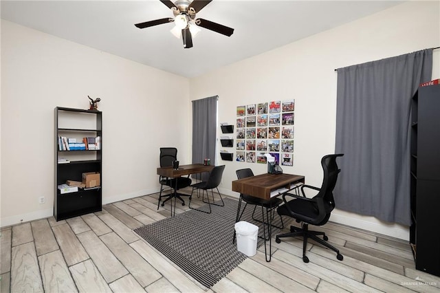 office area with ceiling fan and light hardwood / wood-style floors