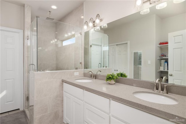 bathroom featuring vanity, tile patterned floors, and a shower with shower door