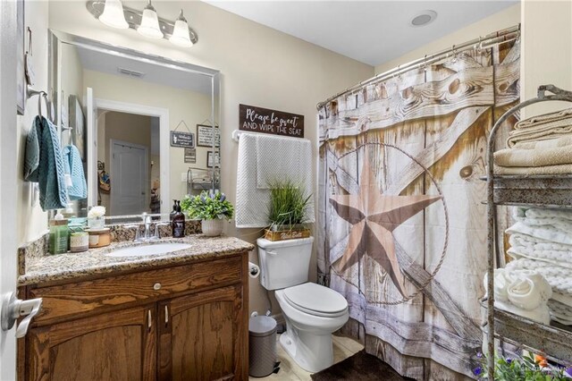 512 S Mina De Oro St, Mission, TX 78572 - bathroom with toilet, vanity, and a shower with curtain