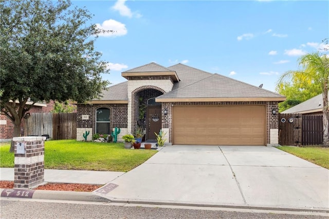 512 S Mina De Oro St, Mission, TX 78572 - view of front facade with brick siding, a garage, concrete driveway, and roof with shingles