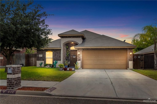 512 S Mina De Oro St, Mission, TX 78572 - view of front facade featuring brick siding, a garage, driveway, and roof with shingles