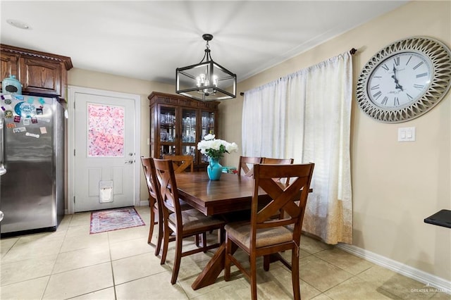 512 S Mina De Oro St, Mission, TX 78572 - dining space featuring a chandelier, light tile patterned floors, and baseboards