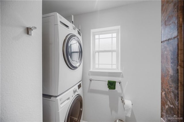 laundry area with stacked washer / dryer