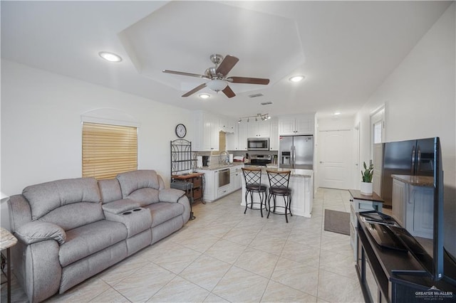 living area with recessed lighting, a ceiling fan, and light tile patterned floors