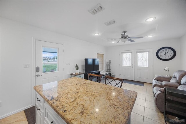 living area featuring visible vents, recessed lighting, light tile patterned floors, and a healthy amount of sunlight