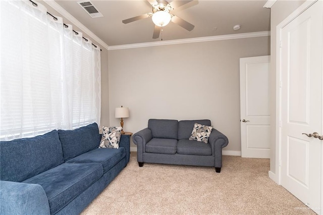 carpeted living room with ceiling fan and ornamental molding