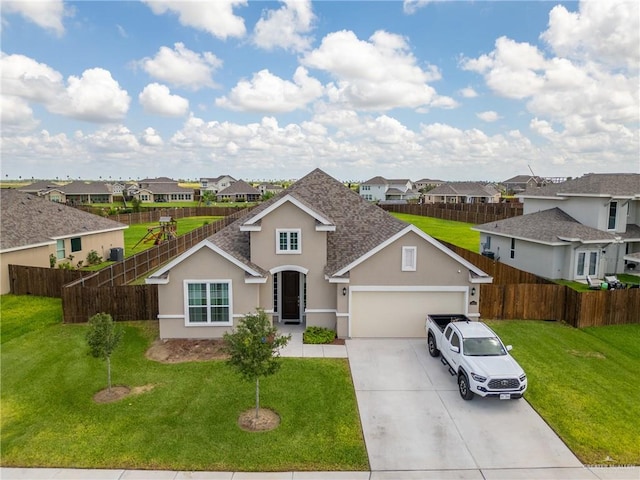 view of front of home featuring a front yard and a garage