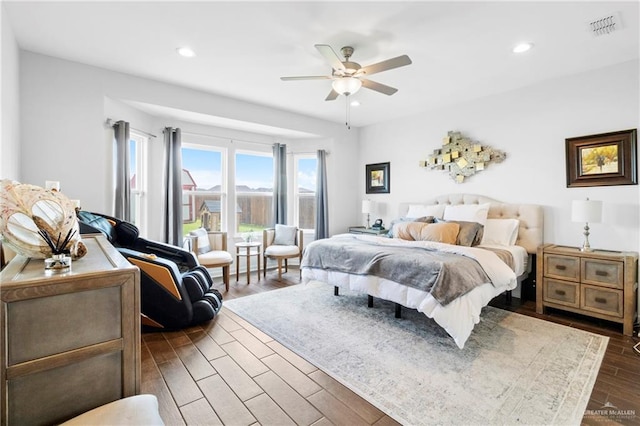 bedroom with dark hardwood / wood-style flooring and ceiling fan