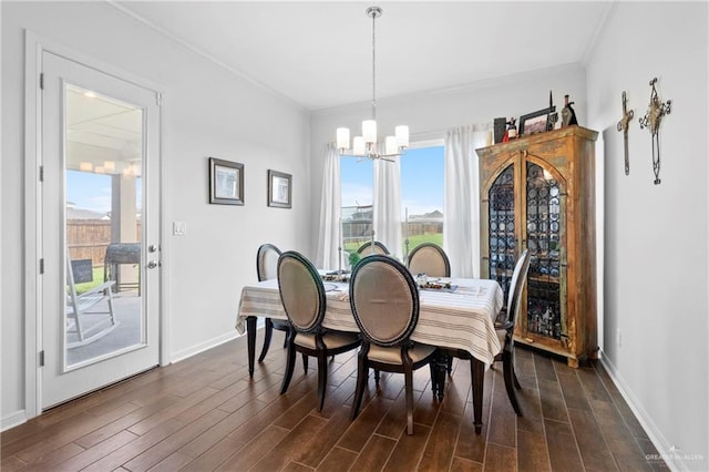 dining area with a notable chandelier, plenty of natural light, crown molding, and dark wood-type flooring