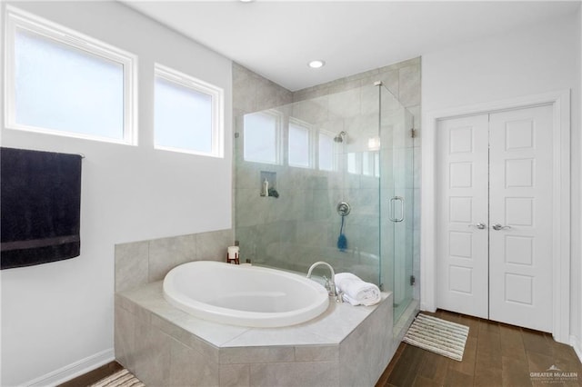 bathroom featuring hardwood / wood-style flooring and separate shower and tub