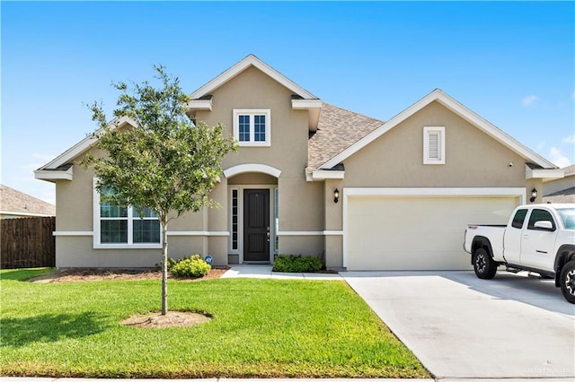 view of property with a garage and a front lawn