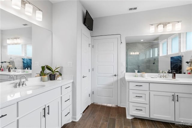 bathroom featuring hardwood / wood-style floors, vanity, and an enclosed shower