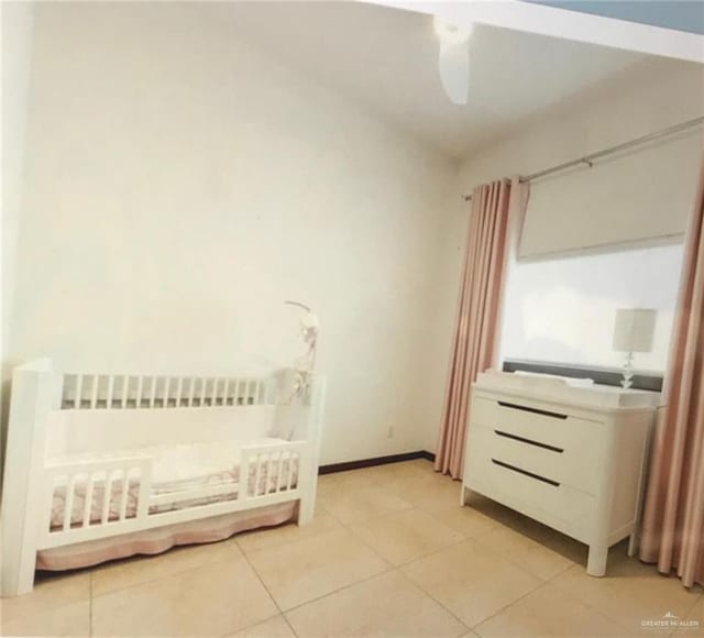 bedroom featuring radiator heating unit and light tile patterned floors