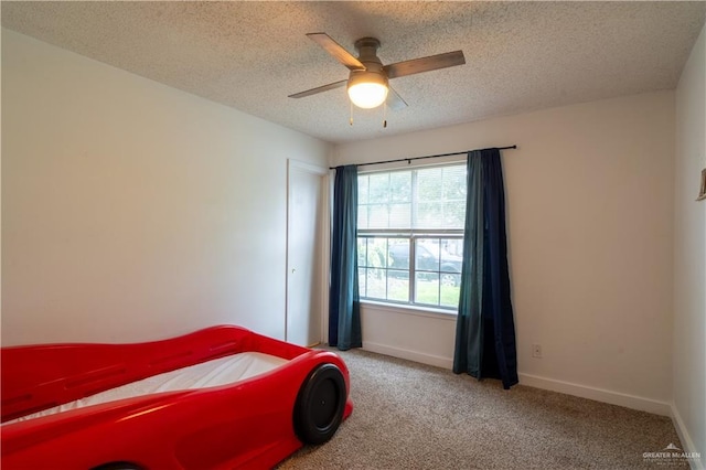 1306 Denver St, Edinburg, TX 78541 - carpeted bedroom featuring a textured ceiling and a ceiling fan