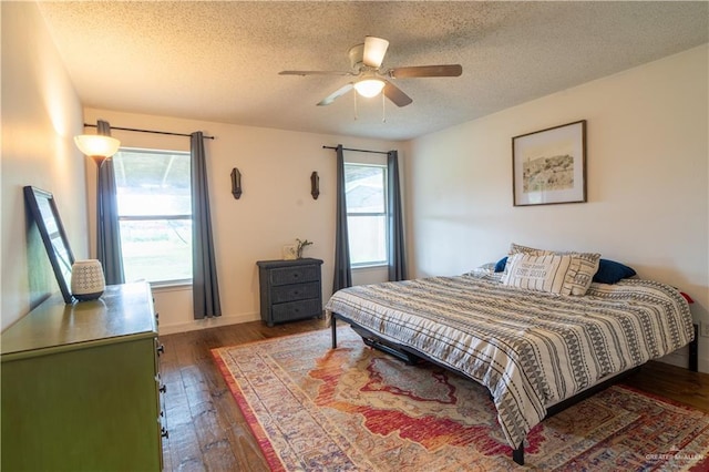 1306 Denver St, Edinburg, TX 78541 - bedroom featuring dark wood-type flooring, a textured ceiling, and ceiling fan