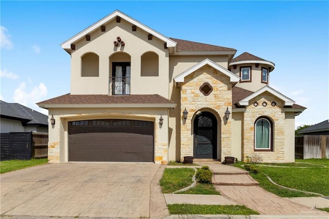 4805 Galilea St, Edinburg, TX 78542 - mediterranean / spanish house featuring stone siding, an attached garage, stucco siding, and driveway