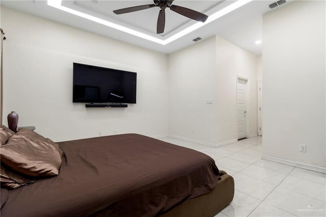 4805 Galilea St, Edinburg, TX 78542 - bedroom featuring baseboards, a ceiling fan, a raised ceiling, and light tile patterned floors