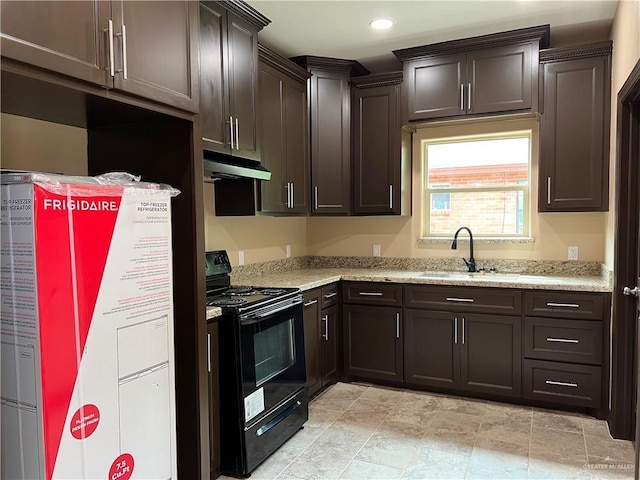 kitchen featuring dark brown cabinetry, light stone counters, a sink, under cabinet range hood, and black range with electric stovetop