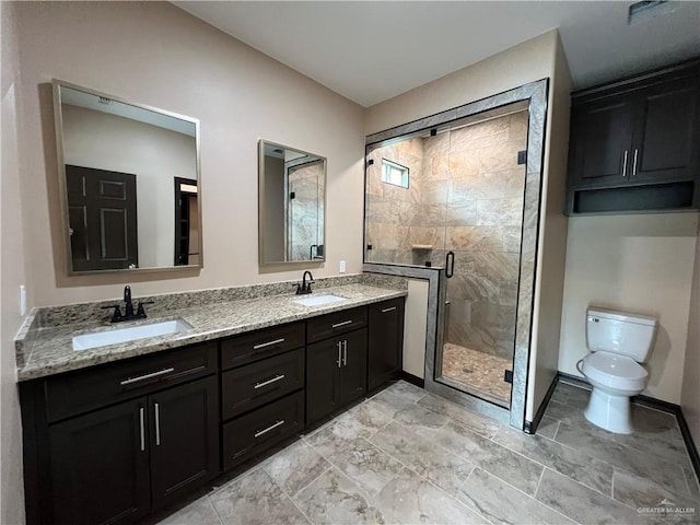 full bathroom featuring a sink, a stall shower, toilet, and double vanity