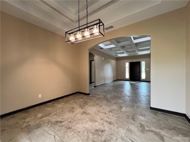 unfurnished room featuring stone finish floor, visible vents, arched walkways, baseboards, and coffered ceiling