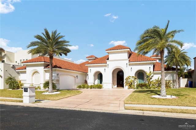 mediterranean / spanish home featuring concrete driveway, a tiled roof, an attached garage, and stucco siding