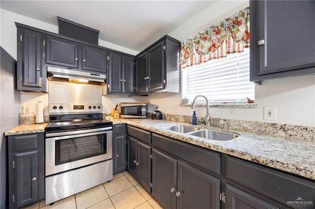 2103 Obra Dorado Rd, Mission, TX 78572 - kitchen featuring under cabinet range hood, appliances with stainless steel finishes, light tile patterned flooring, and light stone countertops