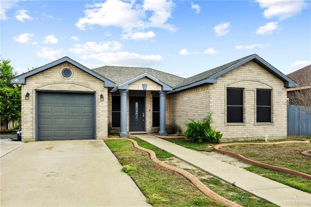 2103 Obra Dorado Rd, Mission, TX 78572 - ranch-style home featuring concrete driveway, brick siding, a garage, and roof with shingles