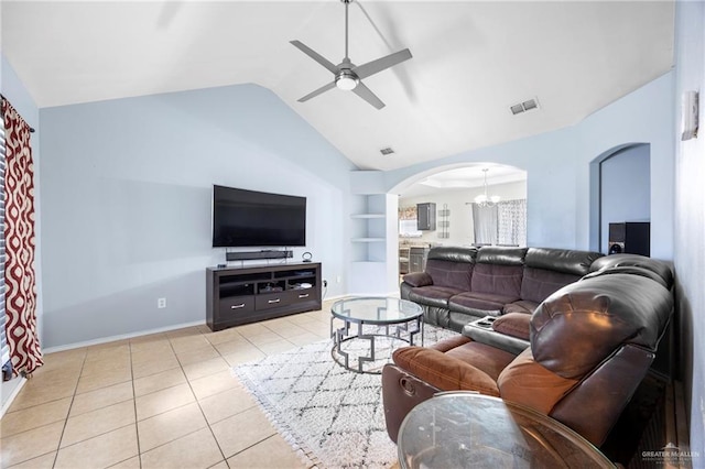 2103 Obra Dorado Rd, Mission, TX 78572 - living room with arched walkways, built in shelves, ceiling fan, light tile patterned floors, and a chandelier