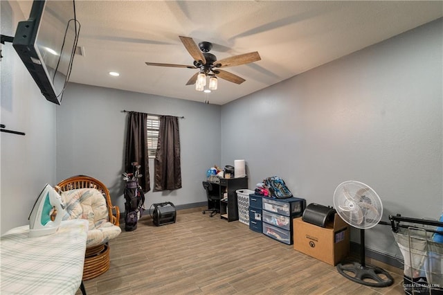 interior space with ceiling fan and hardwood / wood-style floors