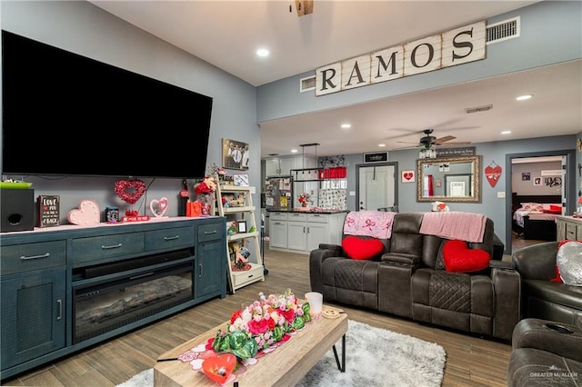 living room featuring ceiling fan and wood-type flooring