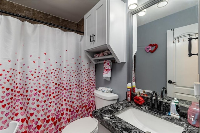 bathroom featuring vanity, a shower with curtain, and toilet