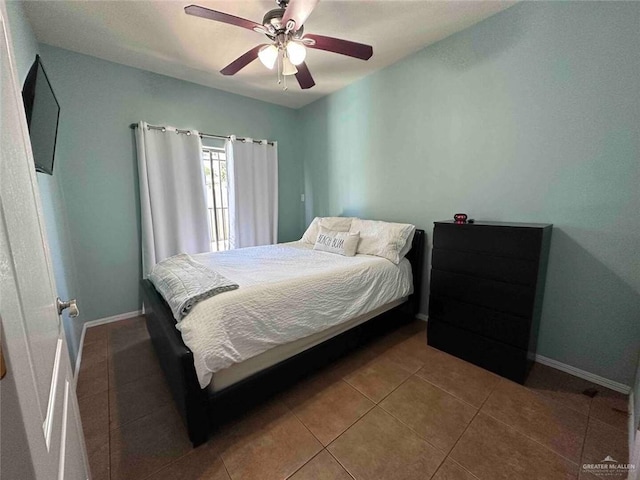 bedroom featuring tile patterned floors and ceiling fan